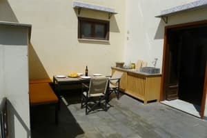 Beautiful terrace with table, chairs and outdoor kitchen